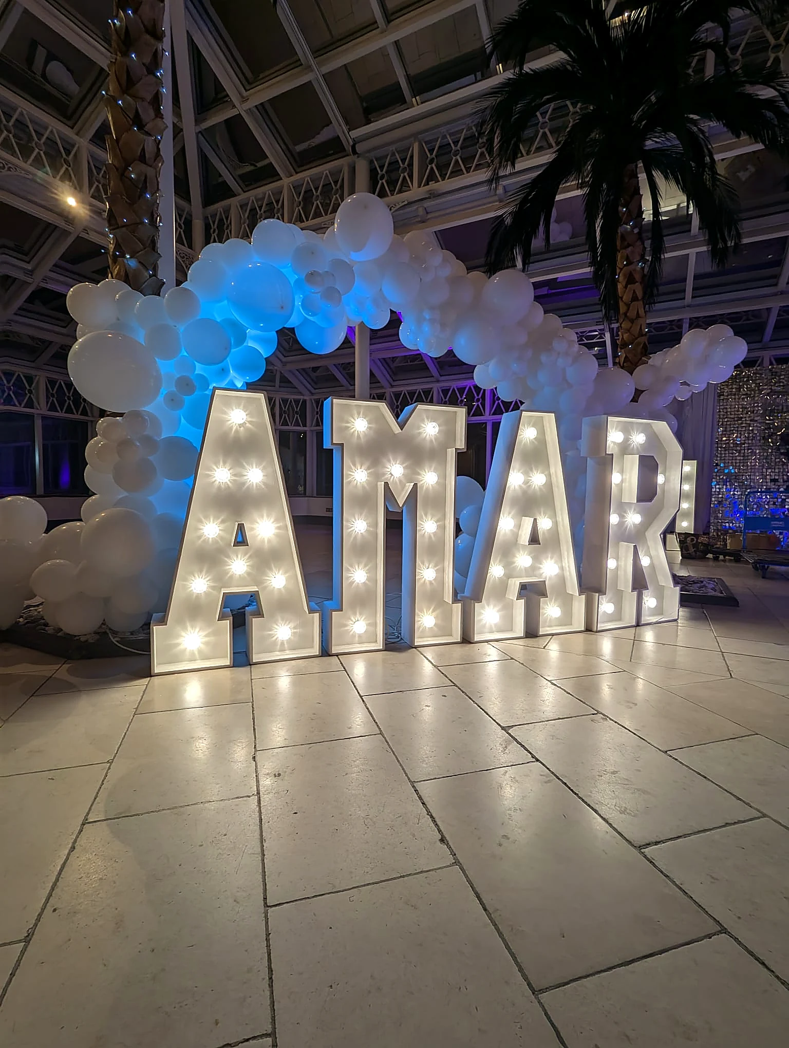 AMAR illuminated letters with white balloon arch
